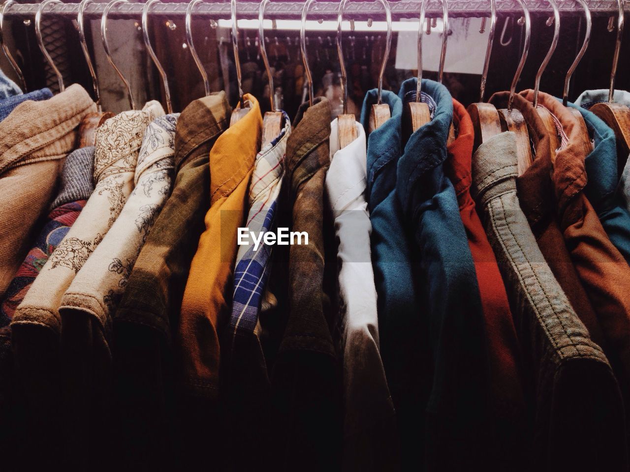 Full frame shot of various clothes hanging in wardrobe