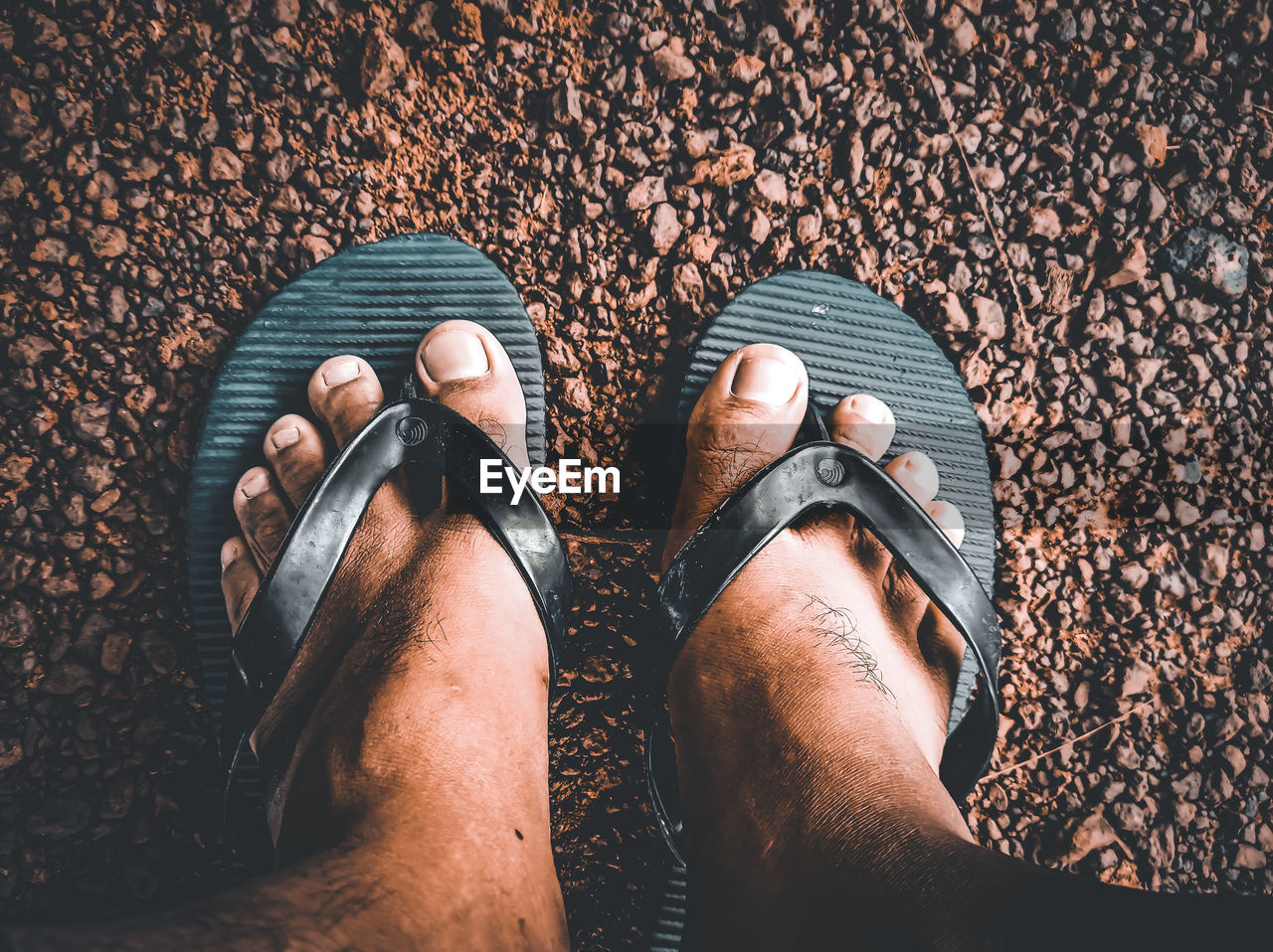 low section, human leg, shoe, personal perspective, one person, standing, lifestyles, human limb, limb, high angle view, footwear, human foot, hand, adult, black, directly above, spring, sandal, close-up, men, leisure activity, finger, day, nature, outdoors, blue, land, fashion, arm, women