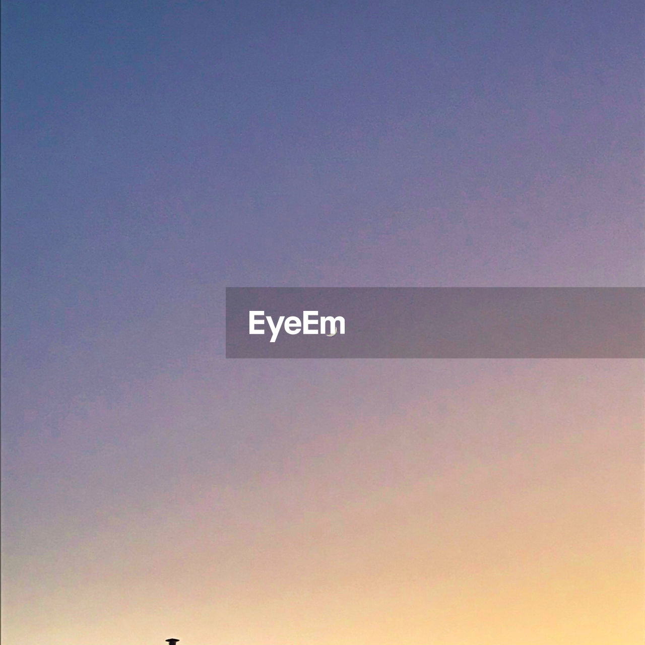 LOW ANGLE VIEW OF MOON AGAINST SKY DURING SUNSET