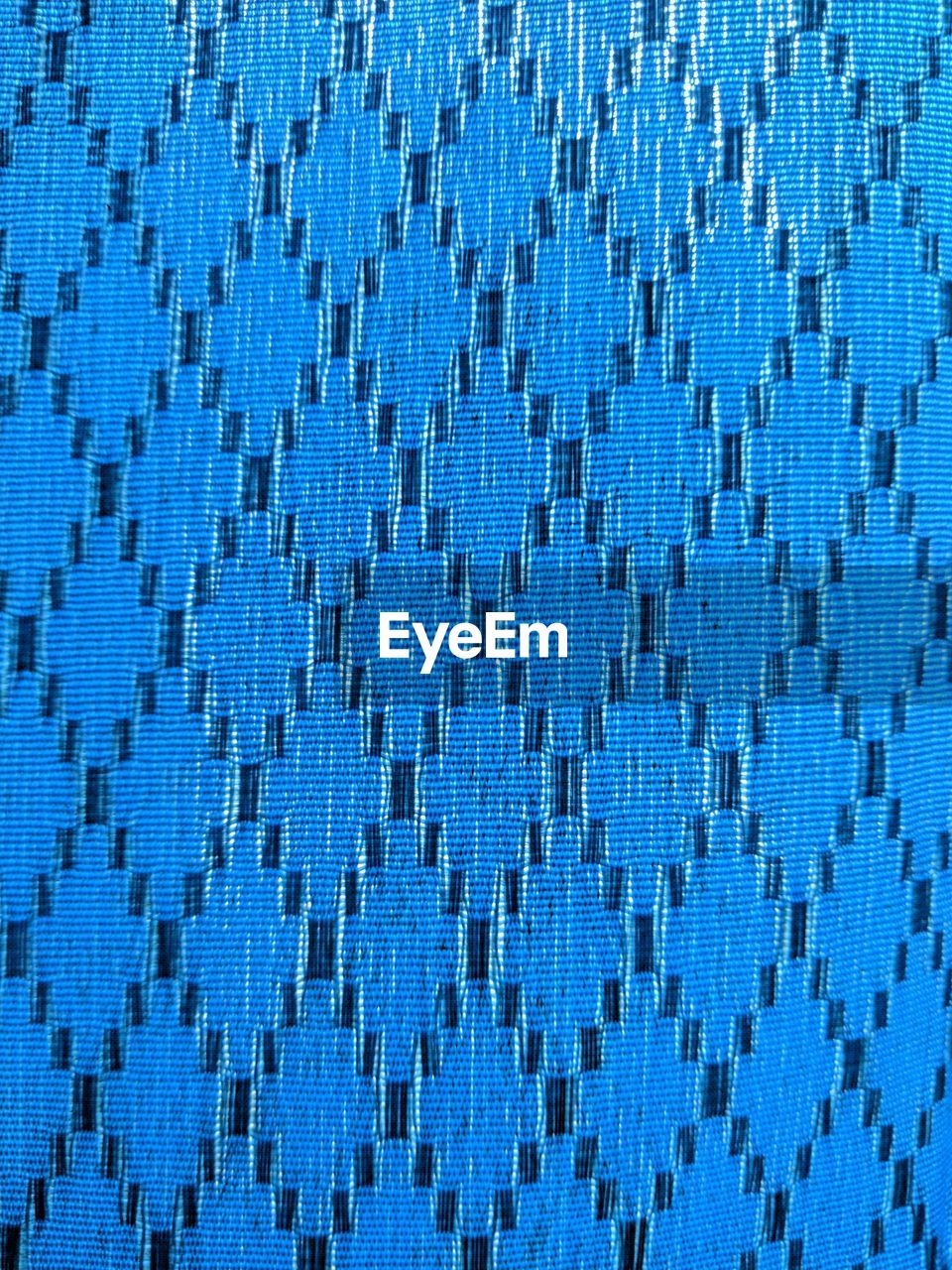 FULL FRAME SHOT OF BLUE PATTERN ON TEXTURED WALL