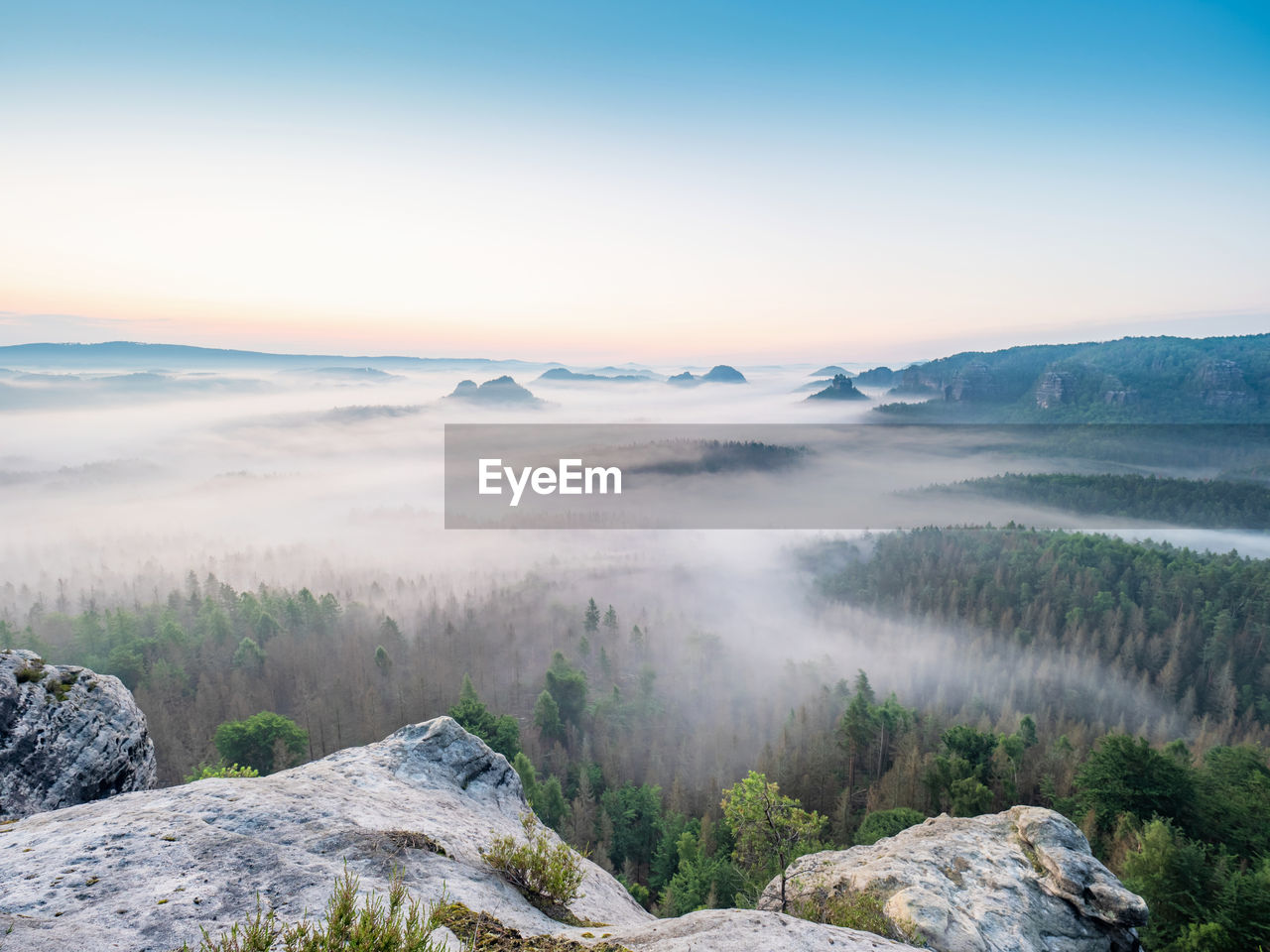 Picturesque sunrise and a foggy morning landscape in the bad schandau nature park region, europe