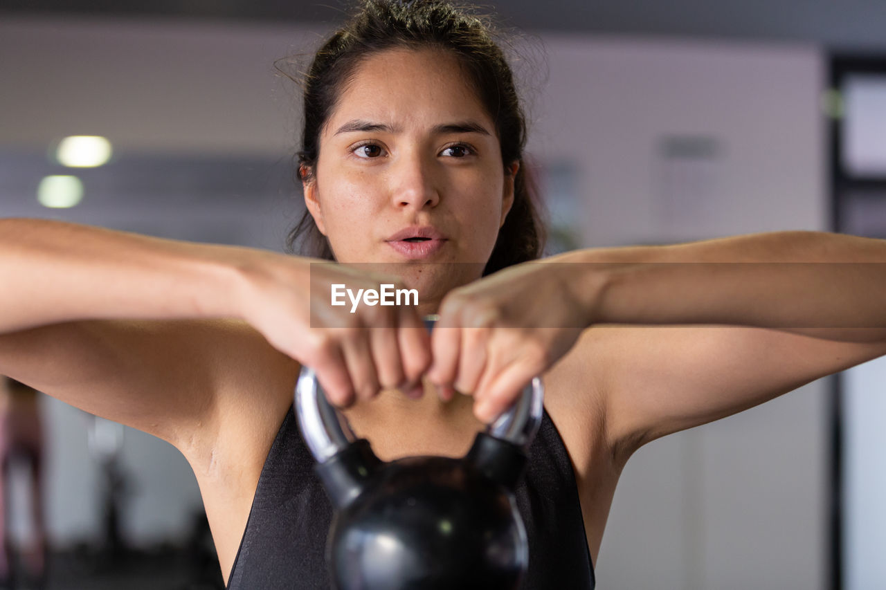 portrait of woman exercising in gym