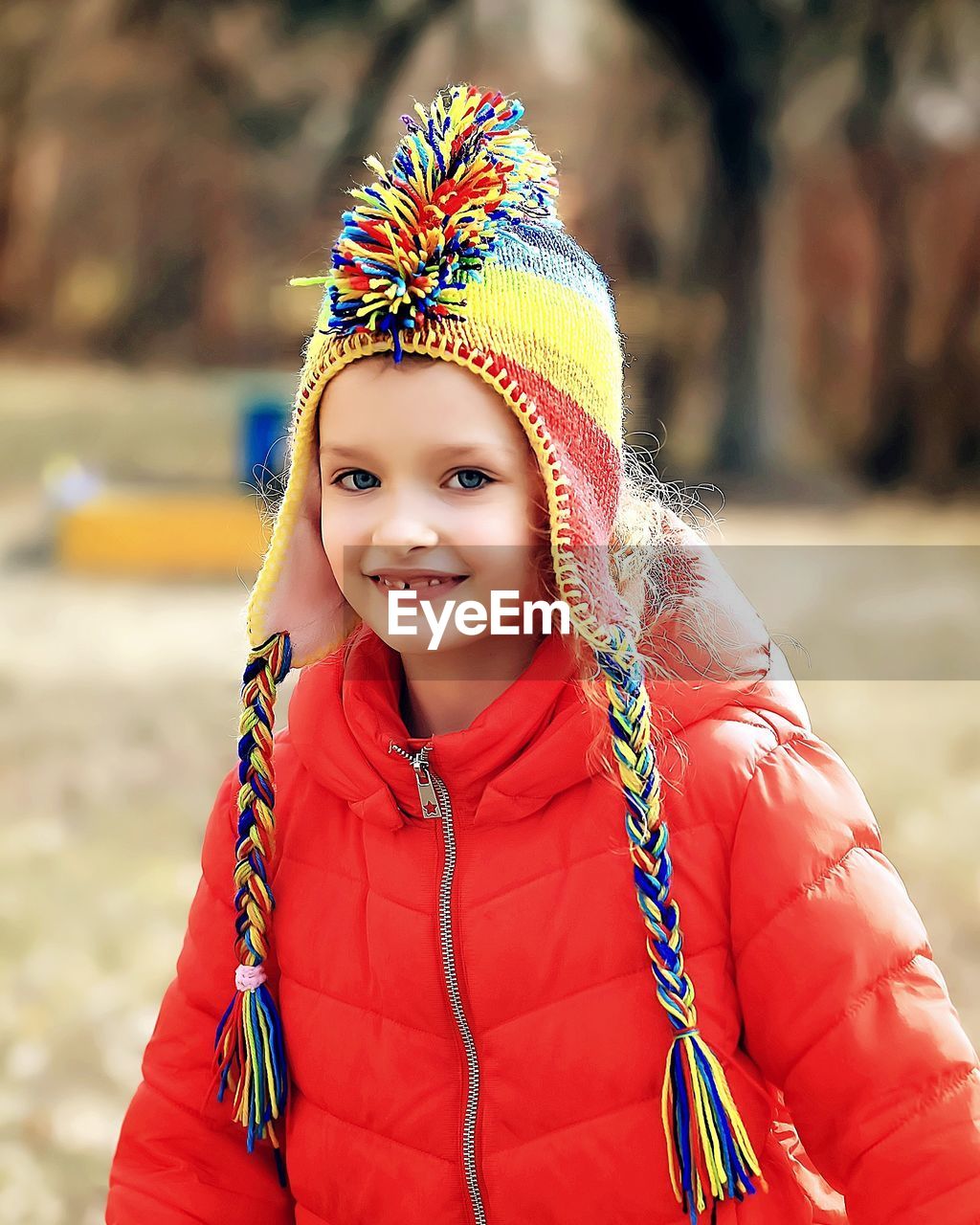 Portrait of smiling girl wearing warm clothing at park