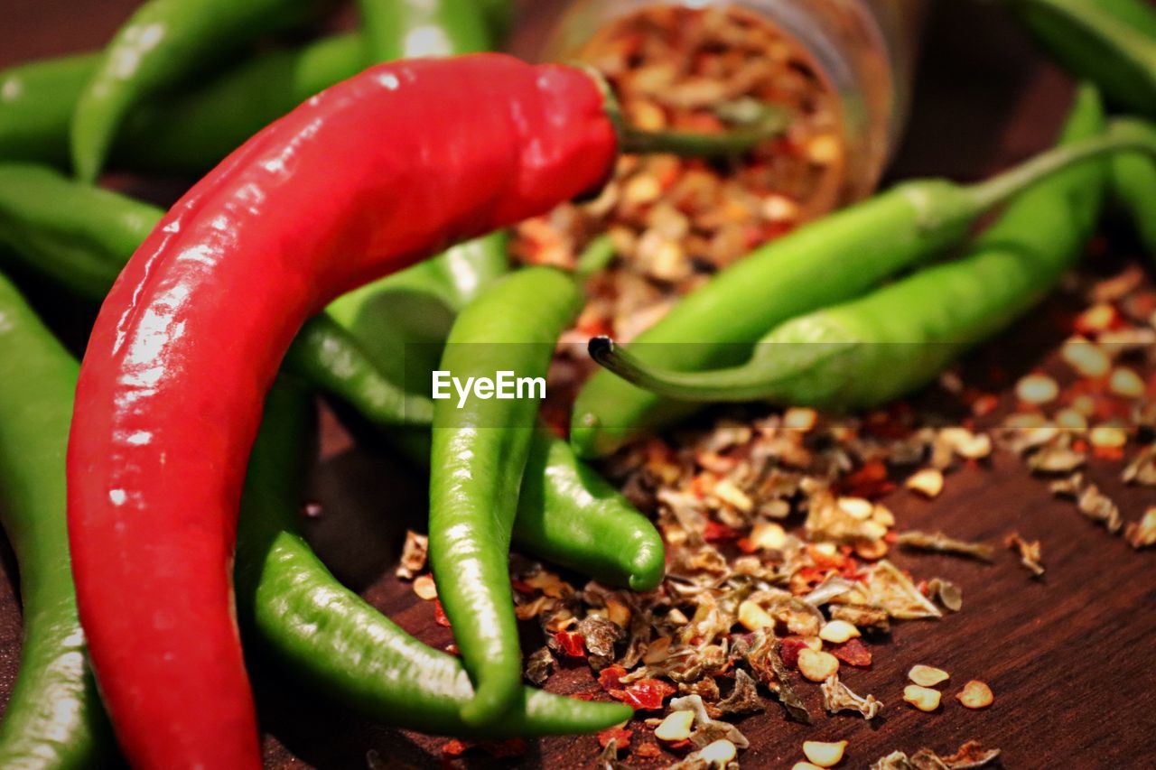 CLOSE-UP OF RED CHILI PEPPERS ON GREEN PEPPER