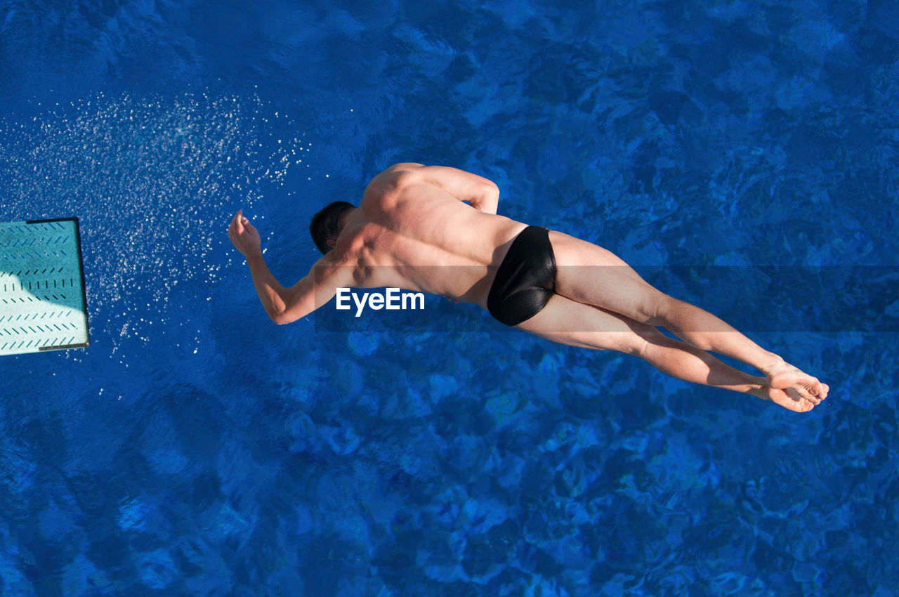 Directly above shot of man jumping in swimming pool
