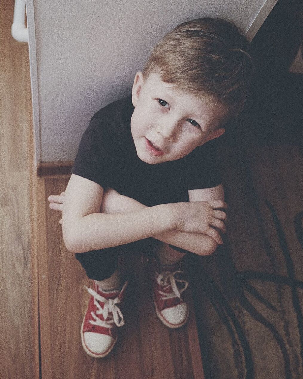 High angle view of boy sitting on floor at home