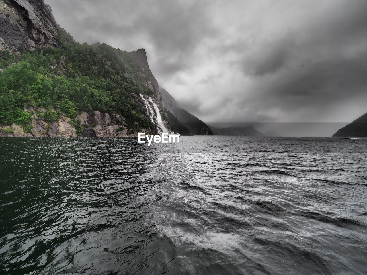 Scenic view of sea and mountains against sky