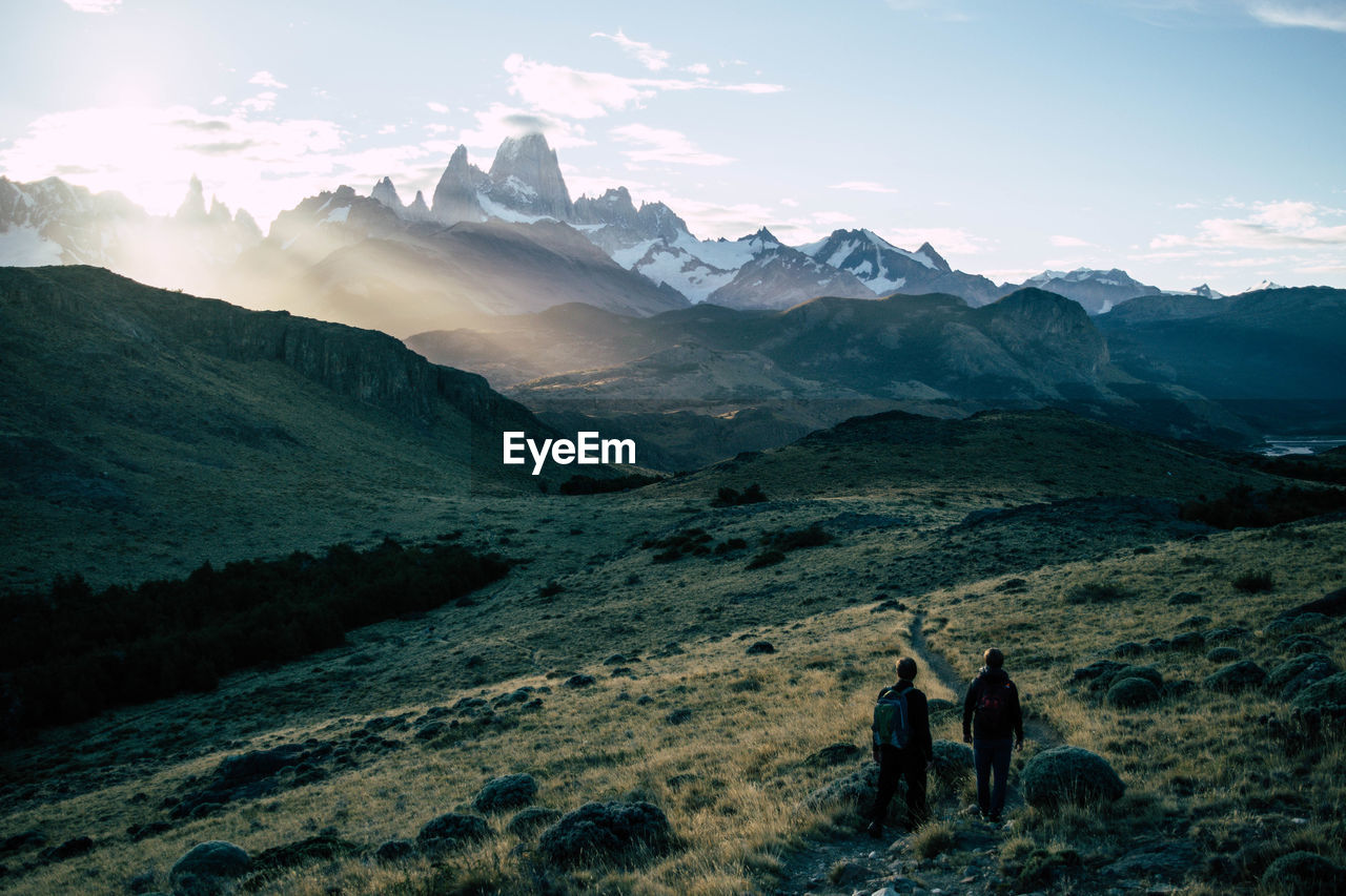Scenic view of snowcapped mountain against sky and sunset