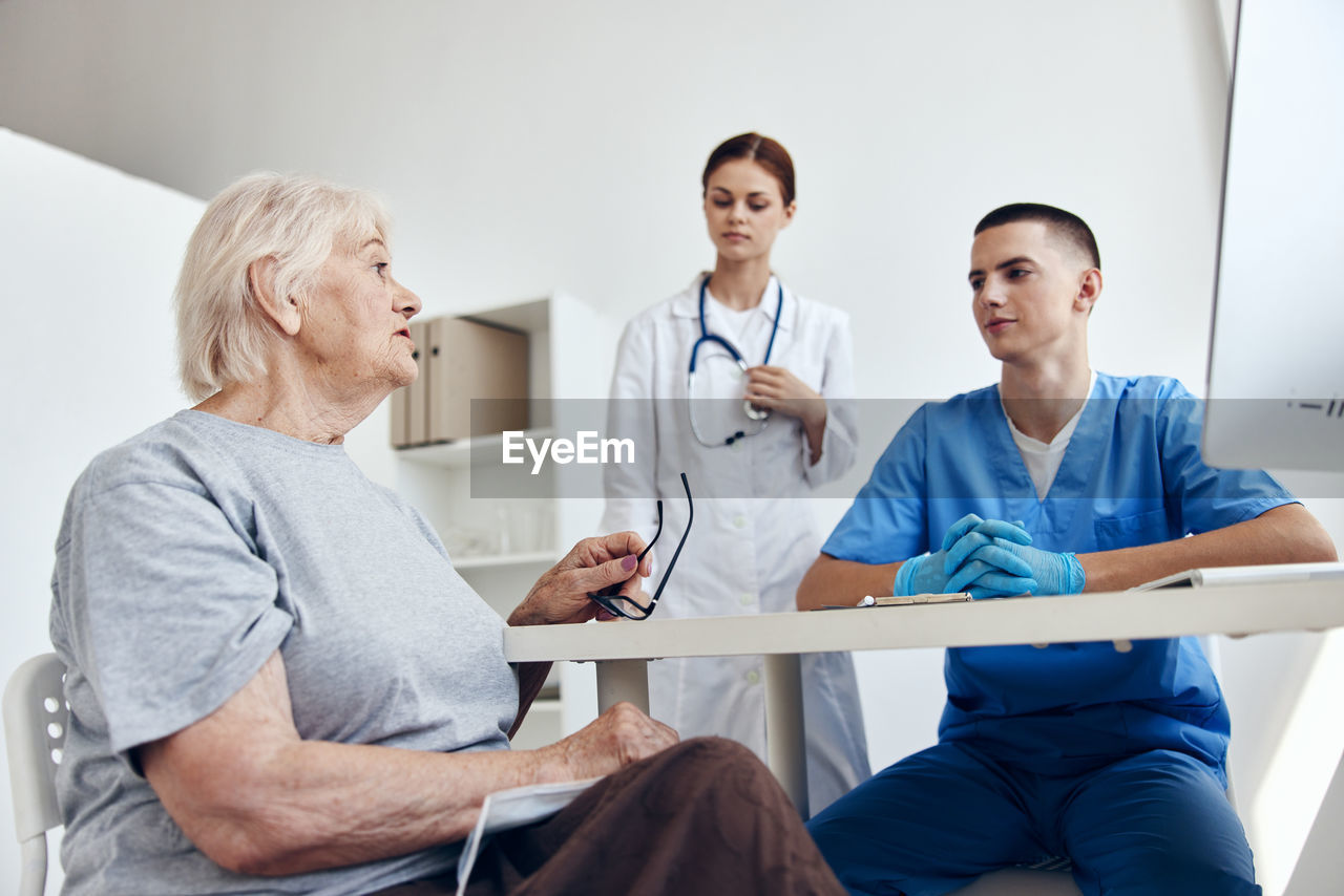 portrait of female doctor explaining to patient at clinic