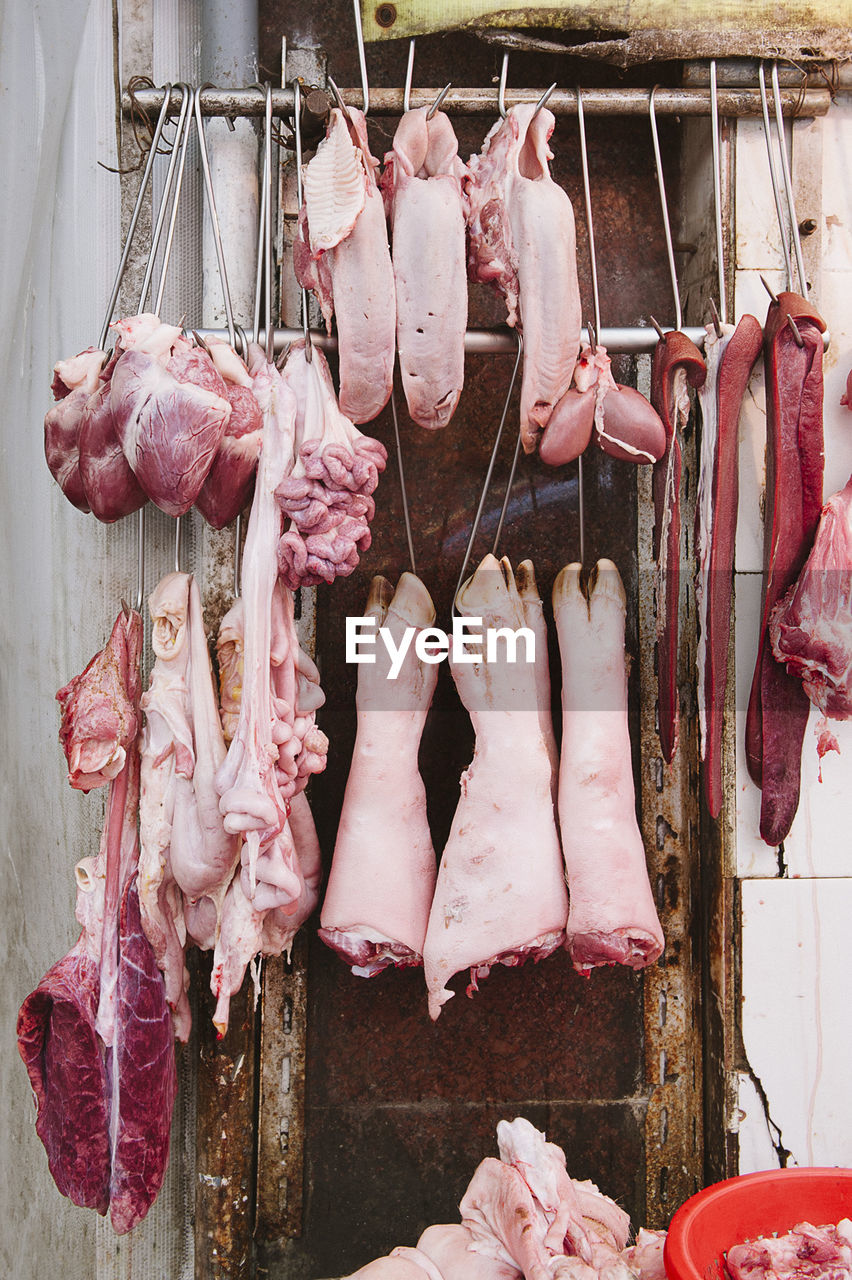 Low angle view of hanging meat parts of a pork