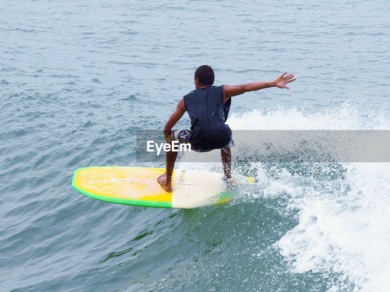 High angle view of man surfboarding in sea