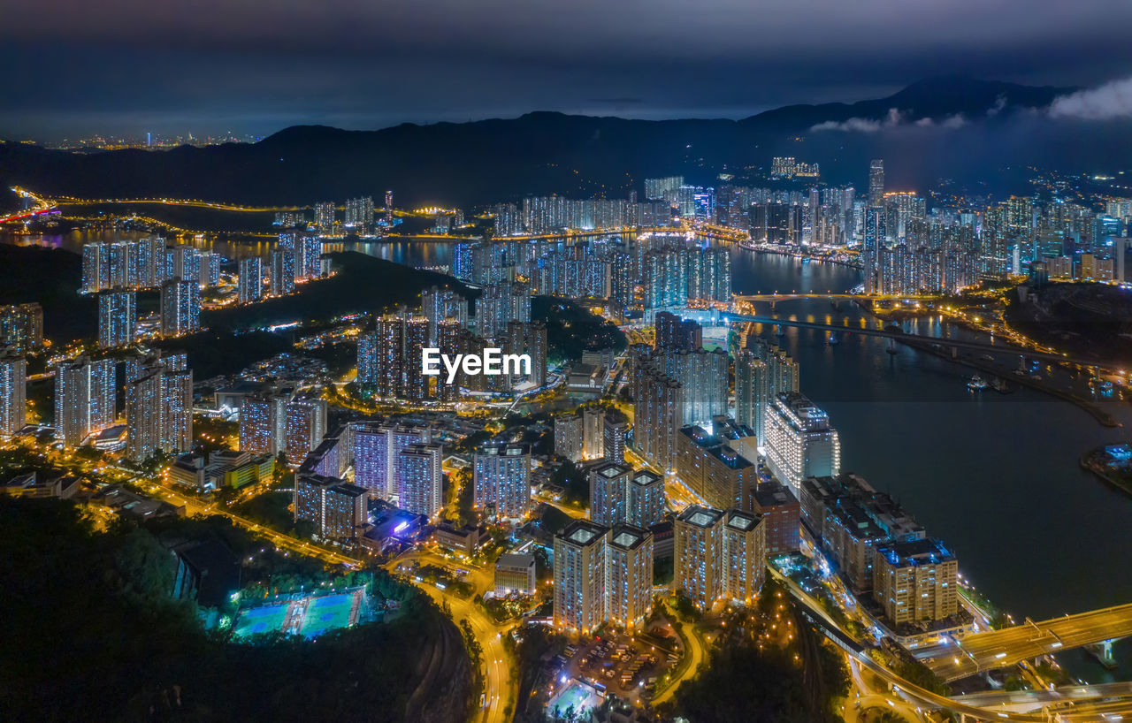 High angle view of illuminated city buildings at night