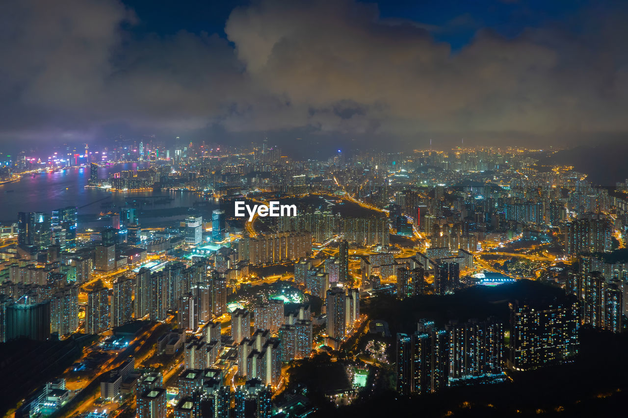 High angle view of illuminated cityscape against sky at night