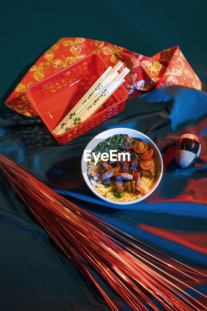 High angle view of food in bowl by fabric and decoration on table