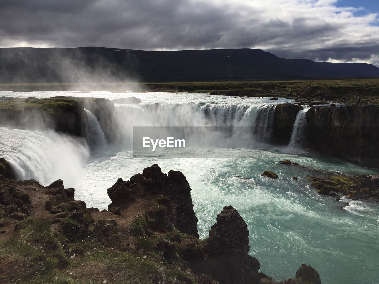 Goðafoss waterfall in iceland on a summer day with lots of clouds