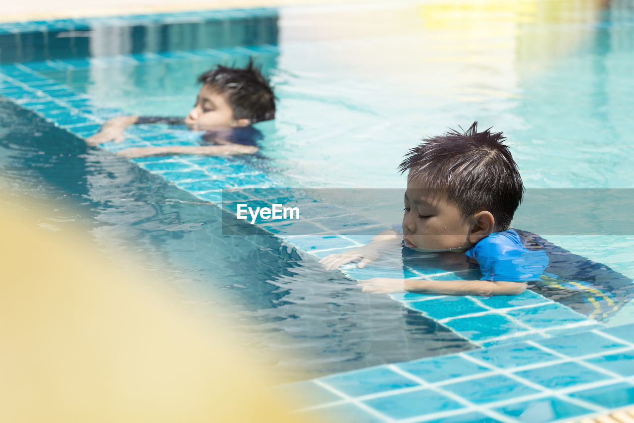 high angle view of boy swimming in pool