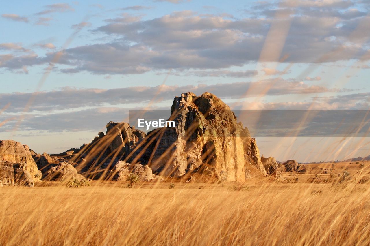 Panoramic view of rock formations on land against sky
