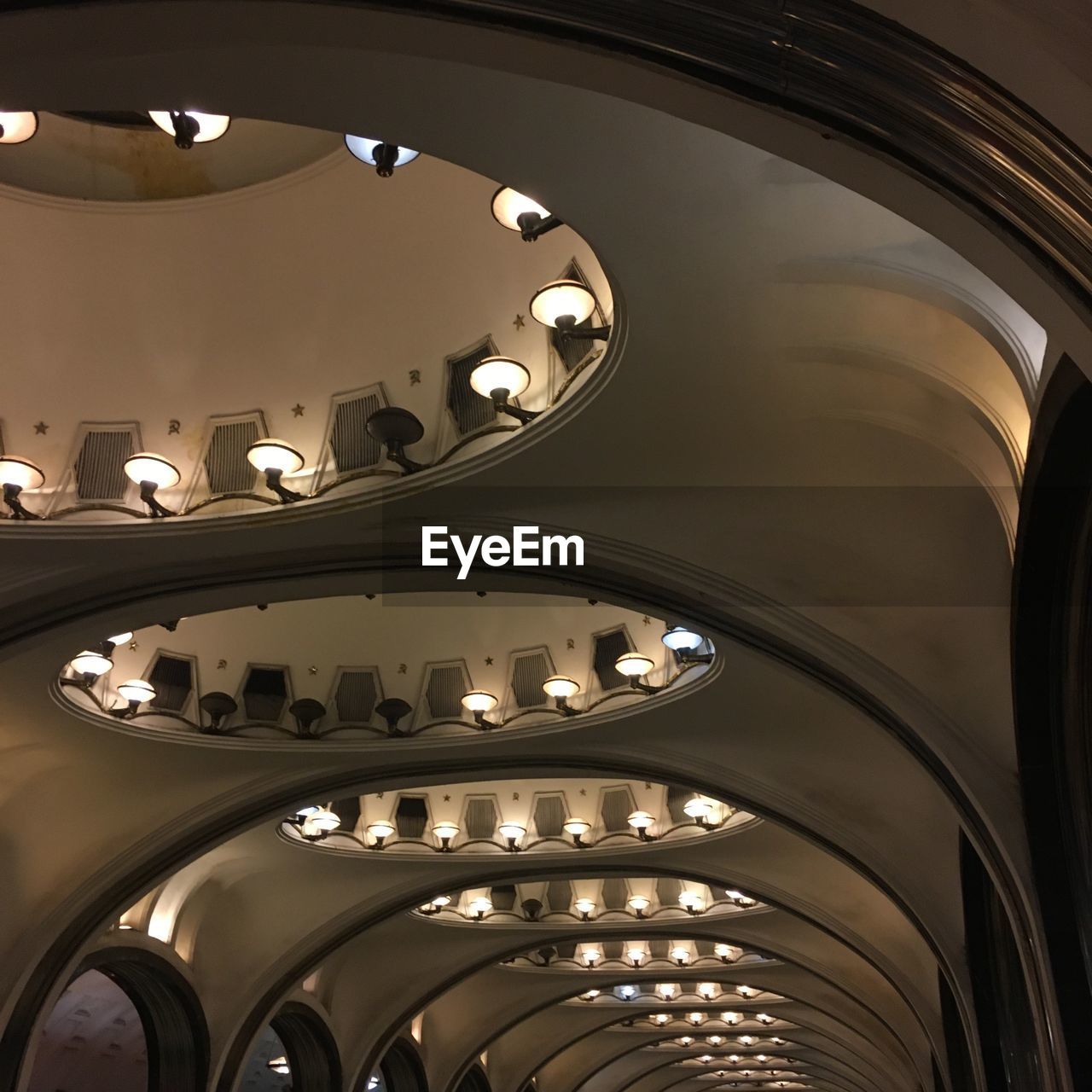 LOW ANGLE VIEW OF ILLUMINATED CEILING LIGHTS ON BUILDING