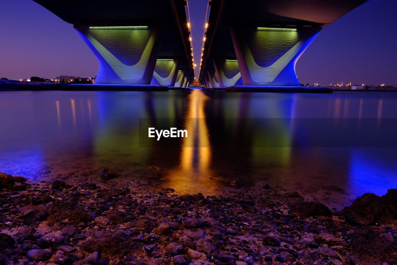 Low angle view of bridge with reflection in water