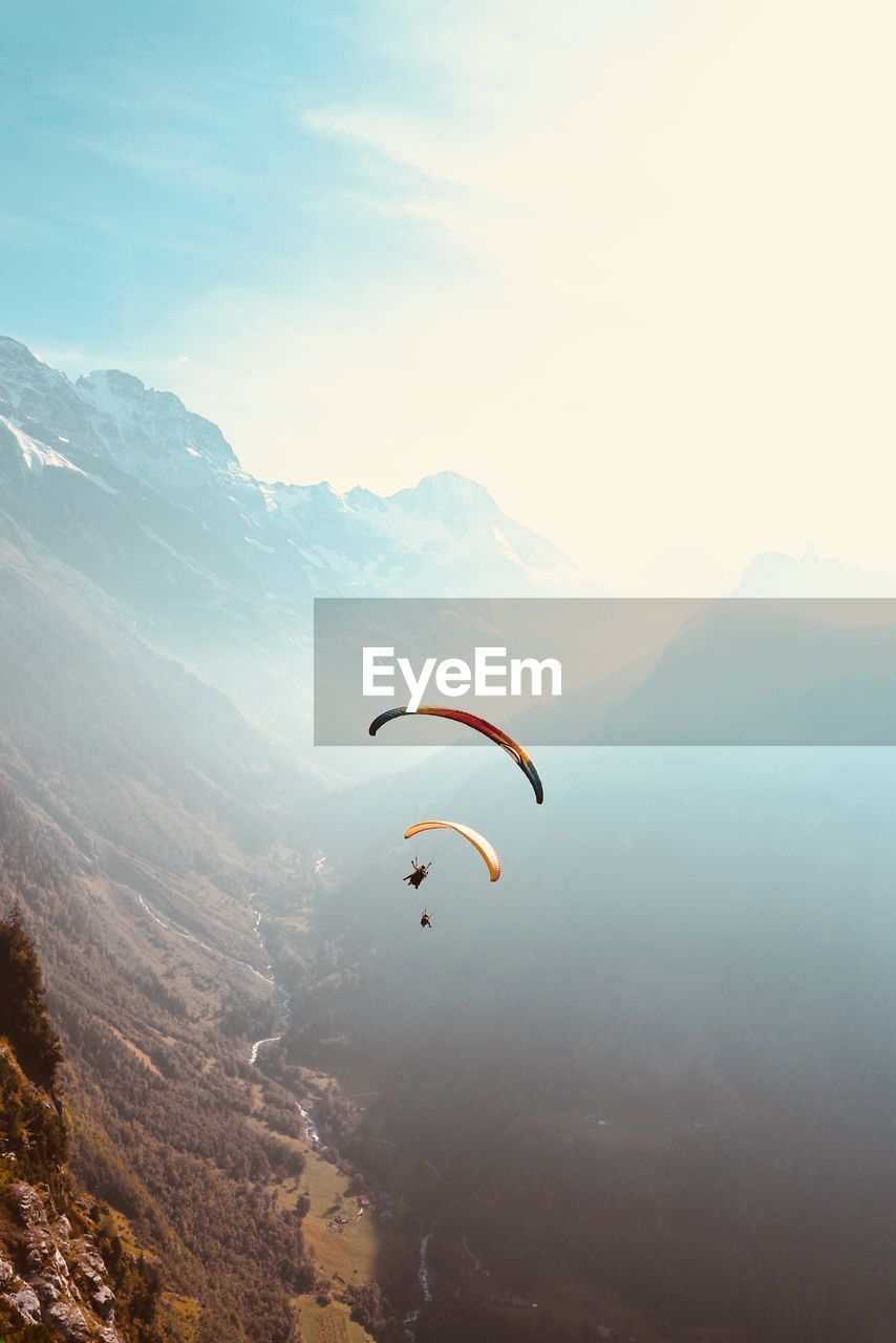 People paragliding against sky