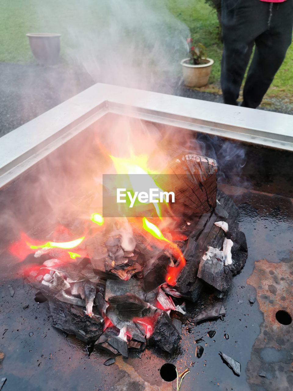 HIGH ANGLE VIEW OF BURNING FIRE ON WOOD