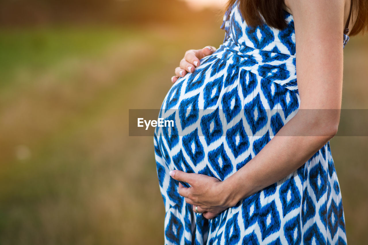 Close-up mid section of pregnant woman