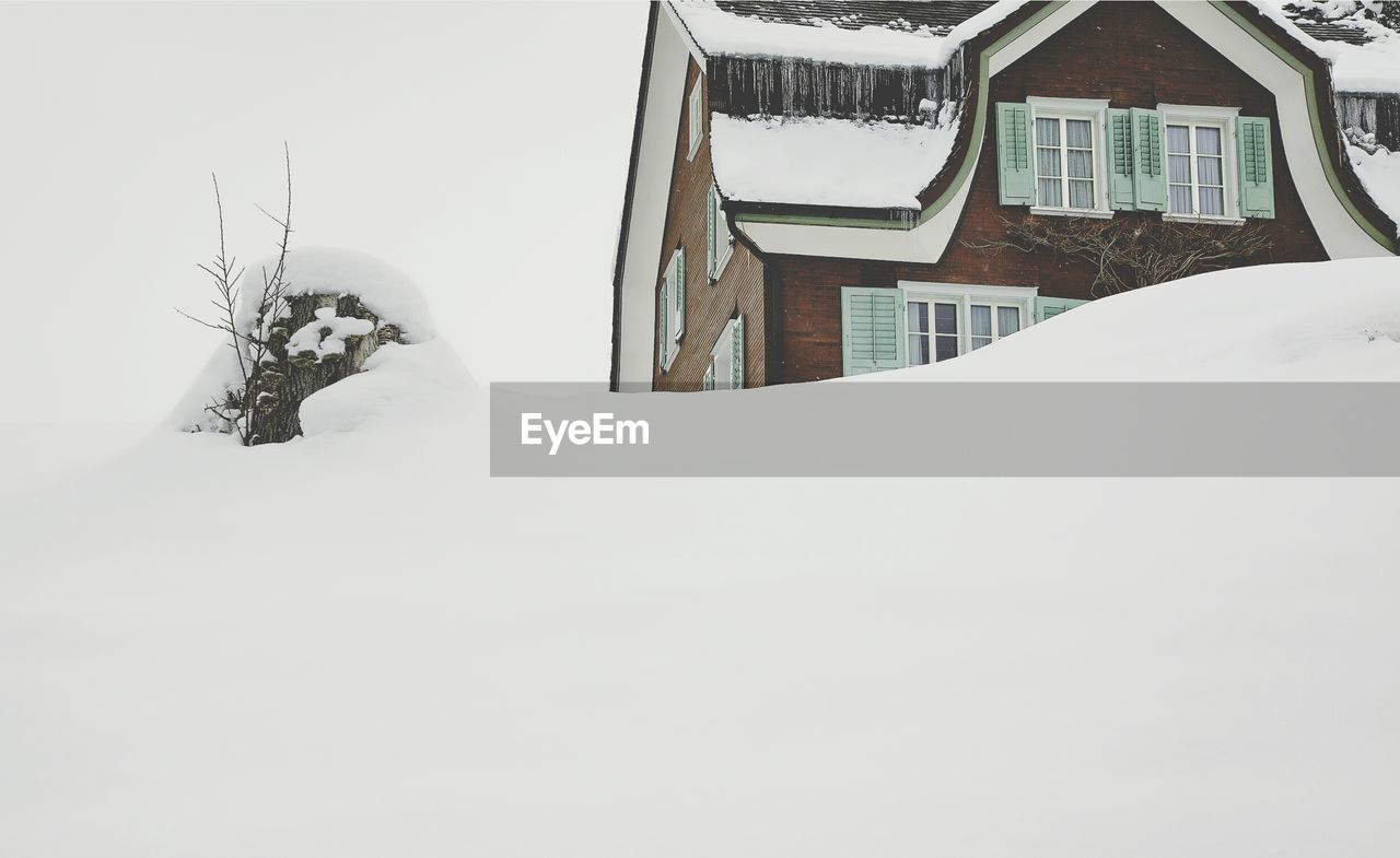 Low angle view of house on snow in winter