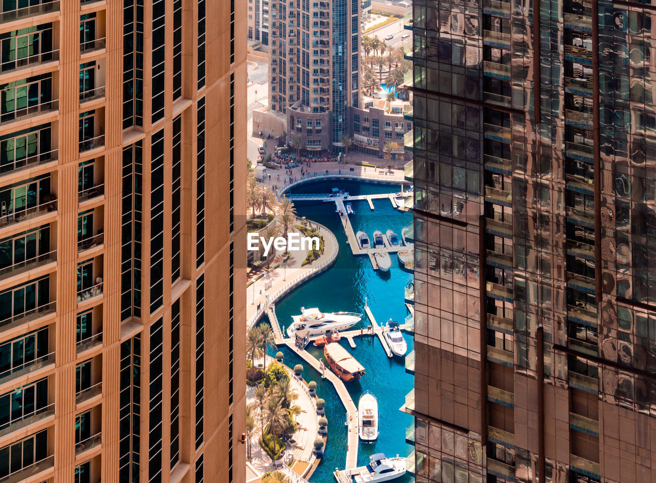 High angle view of harbor seen through buildings in city