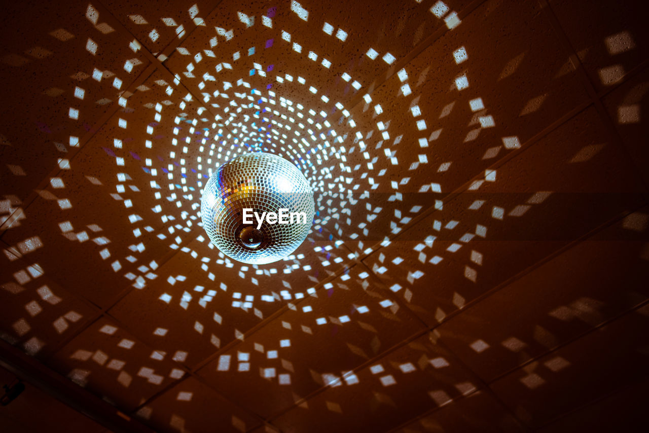 Low Angle View Of Illuminated Disco Ball Hanging On Eyeem