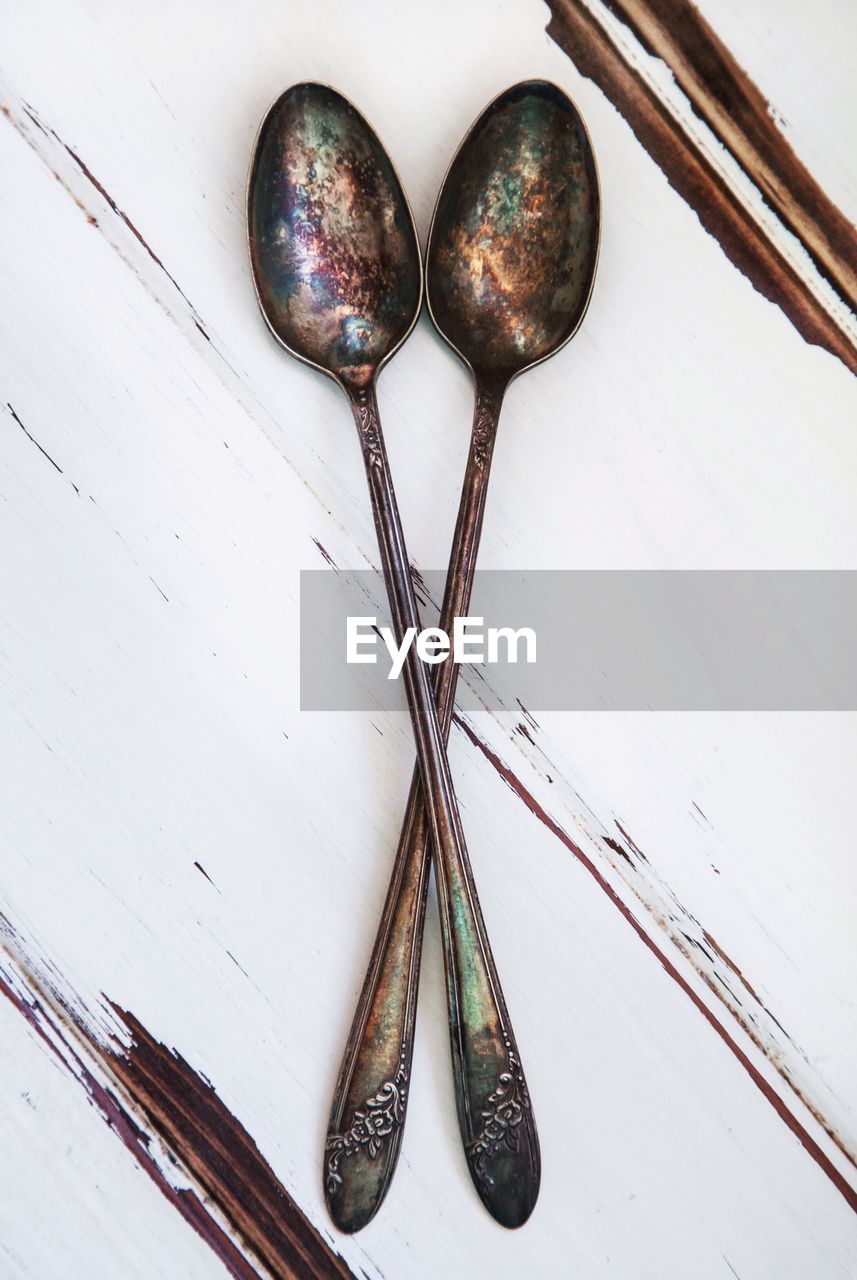 Close-up of rusty spoons on table