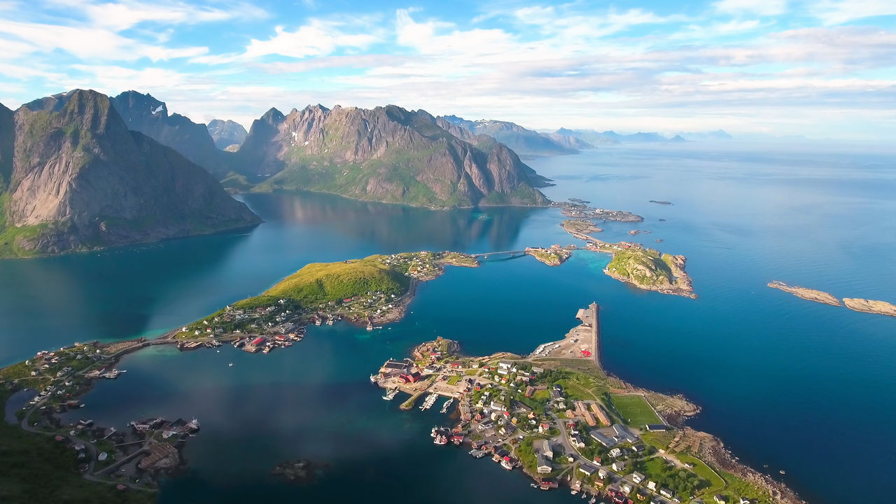 Scenic view of sea and mountains against sky