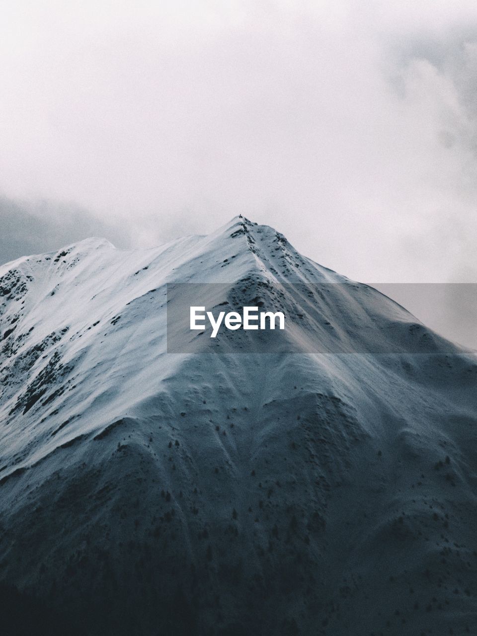 Scenic view of mountains against sky during winter