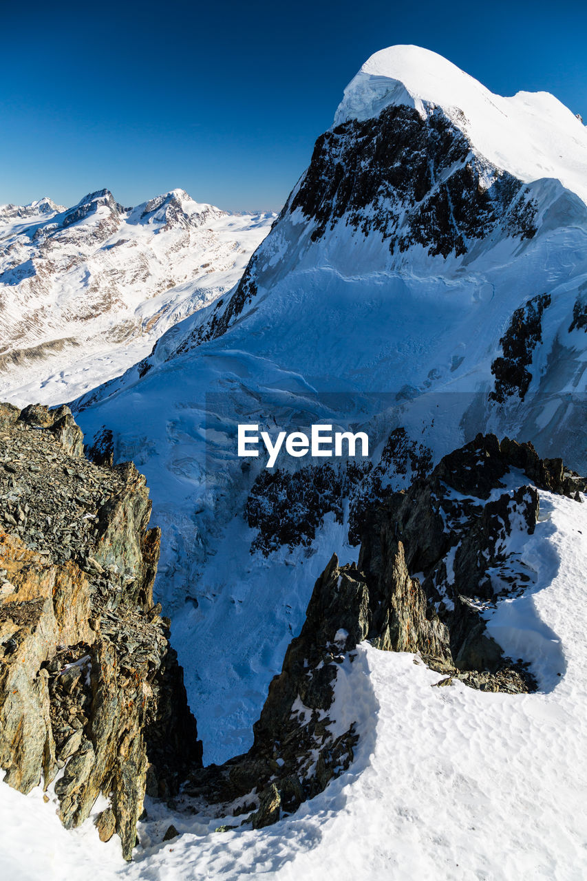 Scenic view of snowcapped mountains against sky. view from klein matterhorn, zermatt