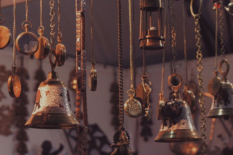 Bells with pocket watches hanging in market for sale