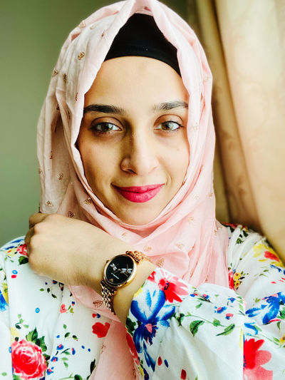 Portrait of smiling young woman wearing hijab 
