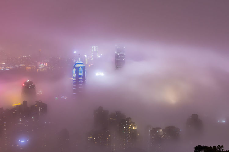 Aerial view of illuminated buildings in city at night