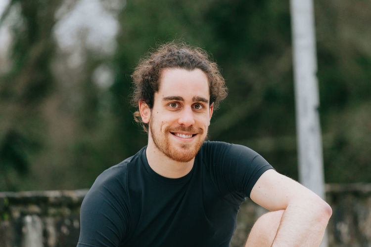Portrait of young man smiling outdoors