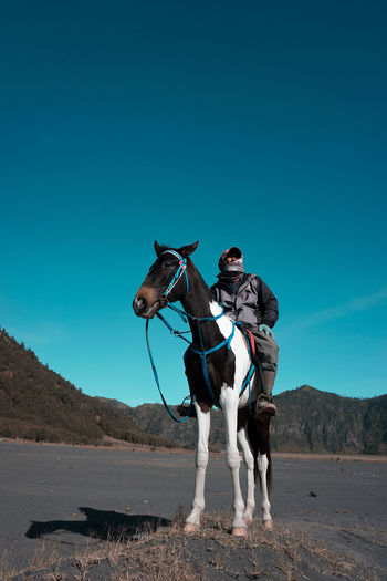 Full length of man riding horse