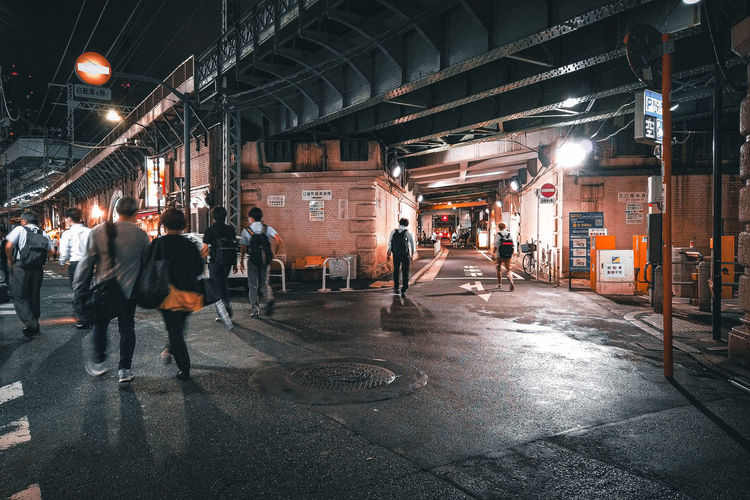 People walking on street at night