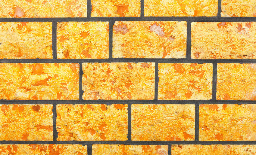 The background and texture of the wall is made of hewn bright yellow stone in the form .