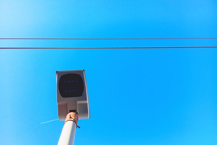 Low angle view of  pole against clear blue sky