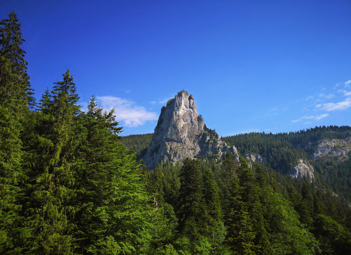 Scenic view of rocky mountains against blue sky