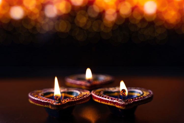 Close-up of illuminated candles burning