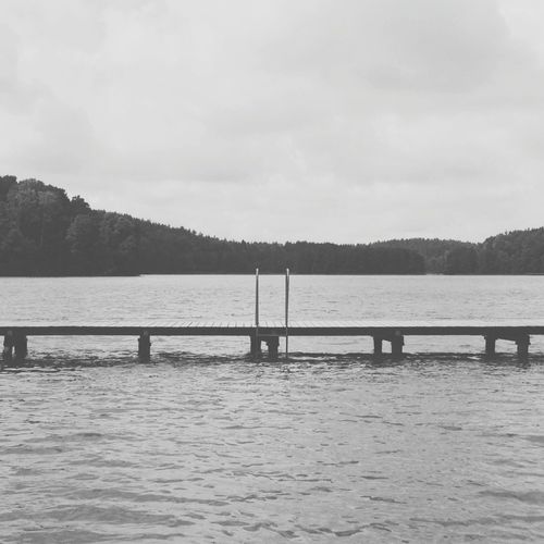 Scenic view of lake against cloudy sky