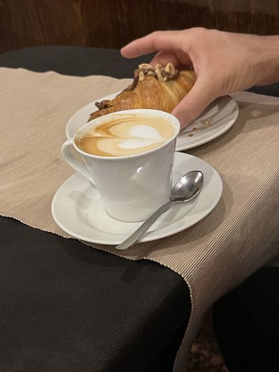 Man holding coffee cup on table