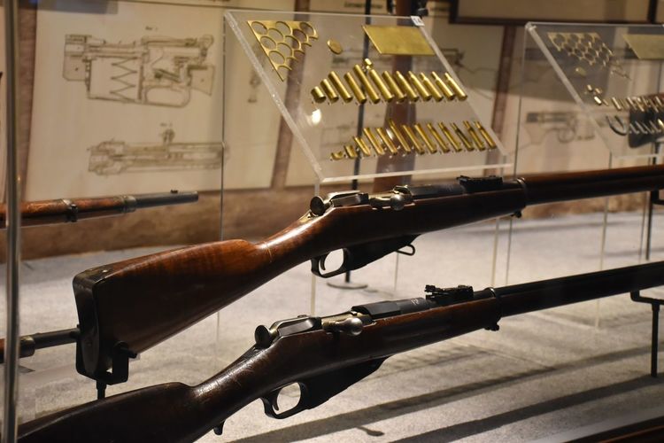 Close-up of rifles and bullets in museum