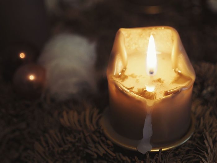 Close-up of illuminated tea light candle