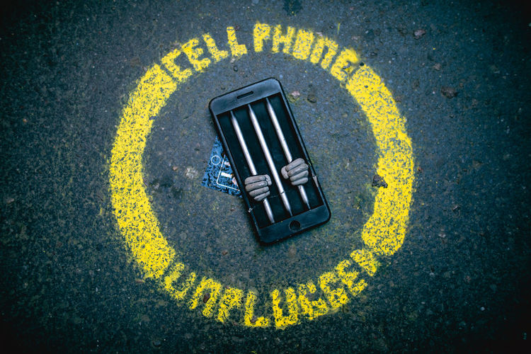 High angle view of mobile phone on road