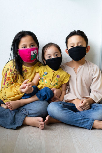 Asian young kids are wearing hygienic reusable face mask to prevent the virus. new normal.