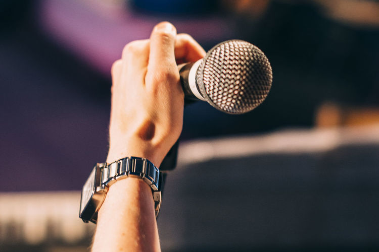 Cropped hand of musician holding microphone